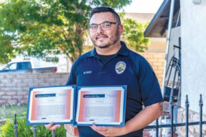 Officer Mike Ogas with his life saving awards
